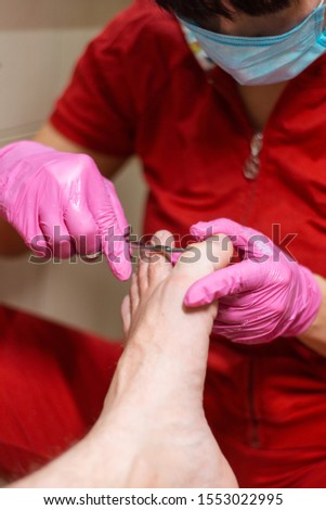 Male pedicure. Pedicurist does the procedure with male feet.