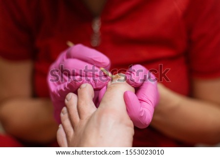 Male pedicure. Pedicurist does the procedure with male feet.