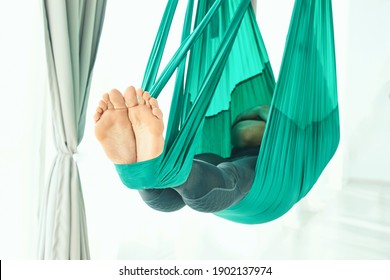 Male person do hammock yoga class exercise. Meditation in air calm. Aero beginner studio workout. Man lifestyle. Guy training zen pose. Green. Hammock stretching at gym