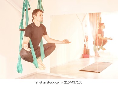 Male Person Do Hammock Yoga Class Exercise. Meditation In Air Calm. Aero Beginner Studio Workout. Man Lifestyle. Guy Training Zen Pose. Green. Lotus Stretching At Gym