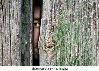 Male Person Hide Behind A Wooden Wall