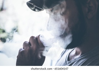 Male Person Holding An Ecig And Vaping 