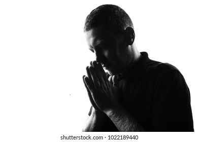 Male person silhouette over white covering his face with hands