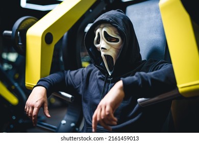 Male Person Wearing Screaming Mask Training At The Gym. Strong Man In Mask Posing In The Gym.