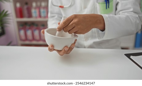 Male pharmacist grinding medicine in a white mortar inside a pharmacy. - Powered by Shutterstock