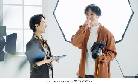 Male photographer and female designer - Powered by Shutterstock