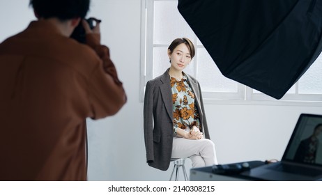 Male Photographer And Female Model Taking A Picture