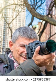 Male Photographer In New York City, Park And Buildings On The Background