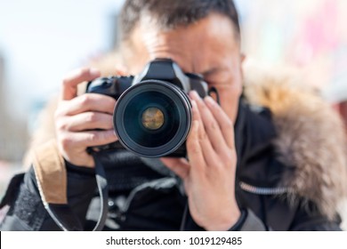 A Male Photographer Takes A Camera With A Camera