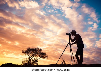 Male photographer taking photos in beautiful nature setting  