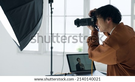 Male photographer taking a picture with a camera