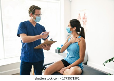 A Male Physical Therapist Stretching A Female Patient Slowly.