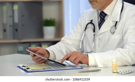 Male Physician Watching Information On Tablet, Online Consultation, Healthcare