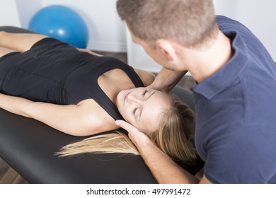 A Male Physio Therapist And Woman Helping Patient