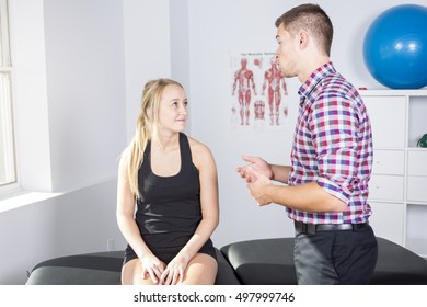 A Male Physio Therapist And Woman Helping Patient