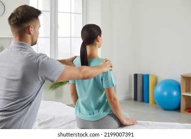 Male physiotherapy doctor work with woman patient relieve backache symptoms. Man physiotherapist help recover female client doing rehabilitation in clinic. Back pain recovery. Medicine concept. - Shutterstock ID 2199007391