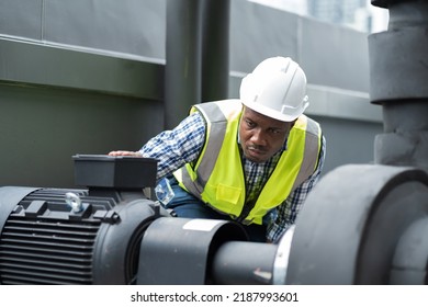 Male plumber engineer or technician worker working in sewer pipes area at construction site. African American male plumber worker check or maintenance sewer pipes network system at construction site - Powered by Shutterstock