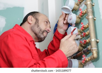 Male Plumber Fixing Water Meter