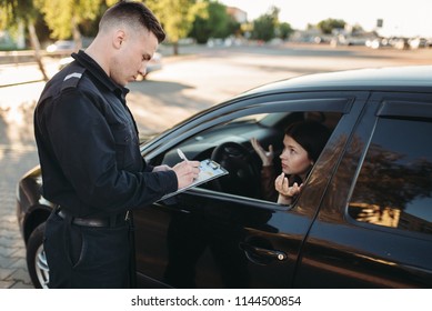 Male police officers check vehicle on the road