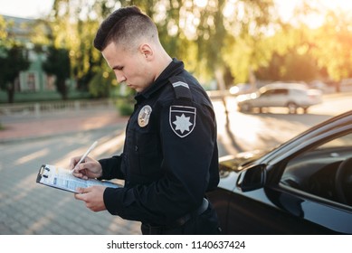 Male Police Officers Writes A Fine On The Road