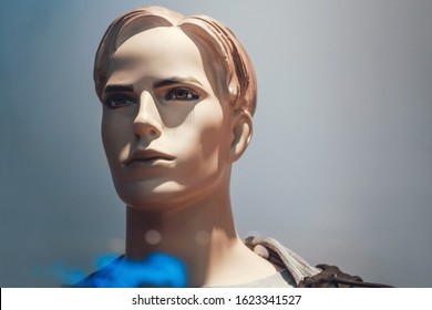 Male Portrait Of Mannequin Isolated On A Blue Background. Body Of Athletic Dummy. Guy's Face. Sports Shop Window For Men