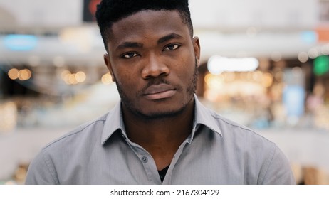 Male portrait young angry serious sad african american man looking at camera negatively shaking head demonstrating negative answer gesture of disapproval disagree rejection forbids denies bad evaluate