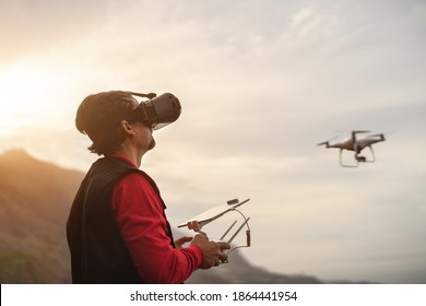 Male professional pilot doing fpv experience with virtual reality glasses and drone - Technology and innovation concept 