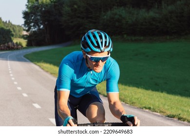 Male Professional Road Cyclist During A Race With Exhausted Face