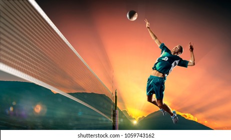 Male professional volleyball player in action at the sunset