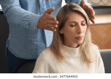 Male psychologist hypnotizing woman in office, closeup - Powered by Shutterstock