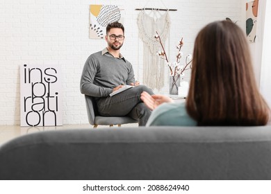 Male Psychologist Working With Patient In Office