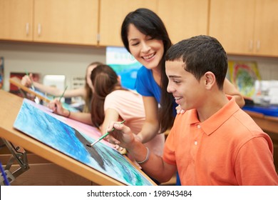 Male Pupil In High School Art Class With Teacher