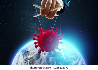 Male Puppeteer Hand Thread Coronavirus On The Background Of The Earth. The Concept Of Shadow Government, World Conspiracy, Manipulation, Control