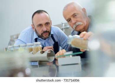 male quality control workers weighing ingredients