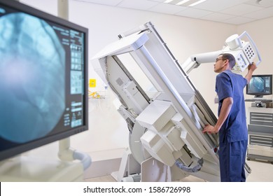 Male Radiographer Working In Hospital X Ray Department