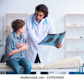 Male Radiologist Looking At Boy's Images