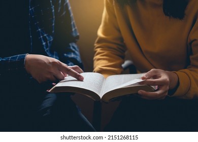 Male Reading The Holy Bible By Pointing To The Character And Sharing The Gospel With A Friend. Holy Bible Study Reading Together In Sunday School.Studying The Word Of God With Friends.