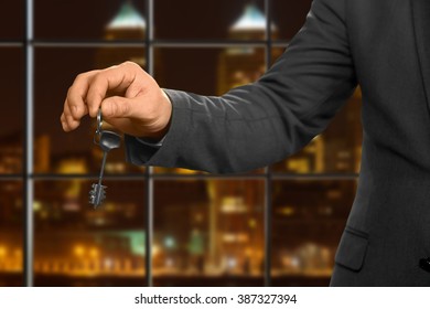 Male Realtor Gives Apartment Key. Night Office Worker Holding Key. Choose The Right Door. Knock And Open.