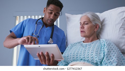 Male Registered Nurse Showing Ill Elderly Woman Electronic Pad