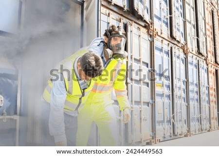 Male rescue workers PPE uniforms wearing gas mask protect against accidental leaks toxic fumes dangerous gases pungent odor keep workers unconscious safe from dangerous toxins inside container.