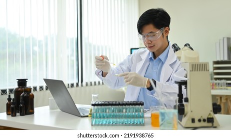 Male Research Scientist Is Conducting Experiment In Laboratory. Medicine And Science Research Concepts