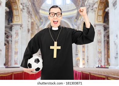 male-reverend-holding-football-cheering-