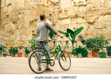 Male Is Riding Bicycle In Na Old Barcelona Street