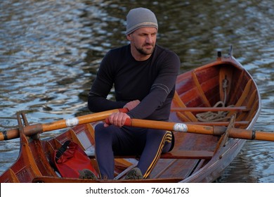 Male Rower On Thames Wearing Beanie Hat In A Skiff Boat