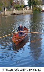 Male Rower On Thames Wearing Beanie Hat In A Skiff Boat