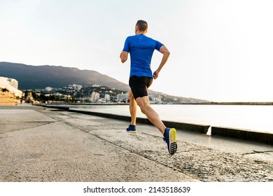 male runner athlete running on sea embankment - Powered by Shutterstock