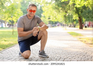 Male Runner Checking Pulse Outdoors