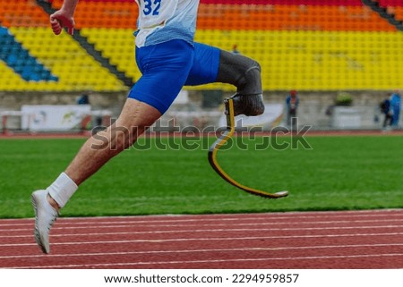 male runner para athlete on limb deficiency running track stadium, summer para athletics championships