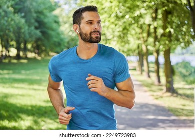 Male runner in park during sunny day in spring or summer  - Powered by Shutterstock