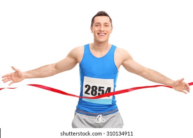 Male runner with a race number on his chest, crossing the finish line isolated on white background